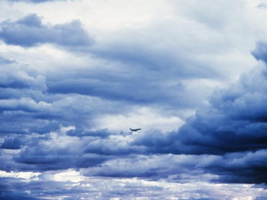 airplane in cloudy blue